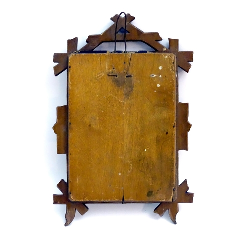 1248 - A 20thC carved wooden photograph frame in the black forest style. Approx. 9