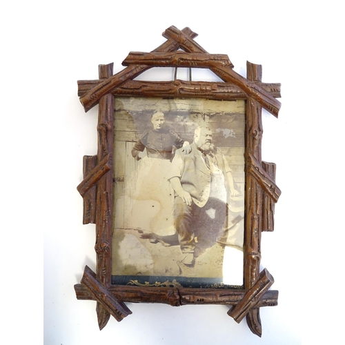 1248 - A 20thC carved wooden photograph frame in the black forest style. Approx. 9