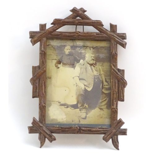 1248 - A 20thC carved wooden photograph frame in the black forest style. Approx. 9