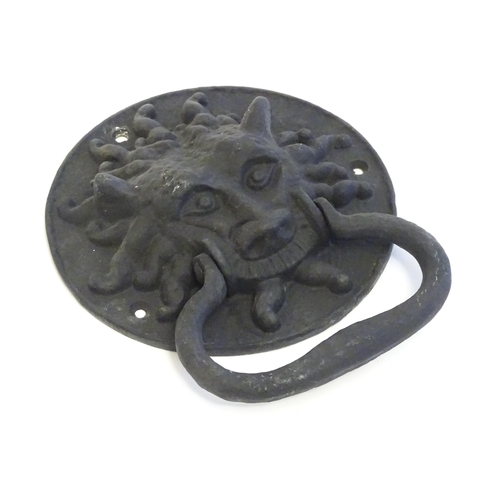 1252 - A 20thC cast door knocker with mask detail. Approx. 8 1/4