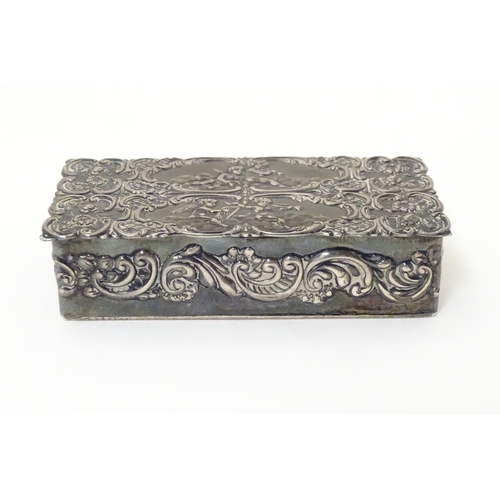 334 - A embossed silver box with a hinged lid opening to reveal a gilded interior, hallmarked London 1974,... 