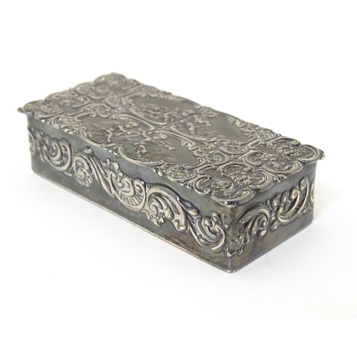 334 - A embossed silver box with a hinged lid opening to reveal a gilded interior, hallmarked London 1974,... 