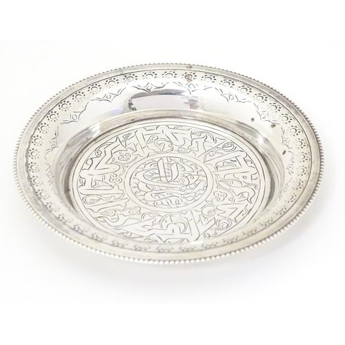 338 - An Egyptian silver dish with engraved decoration. Approx. 2 1/4