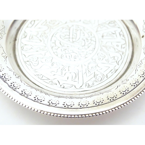 338 - An Egyptian silver dish with engraved decoration. Approx. 2 1/4