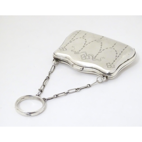 342 - A silver purse with engraved decoration and leather lined interior, hallmarked Birmingham 1914, make... 