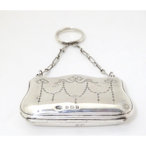 342 - A silver purse with engraved decoration and leather lined interior, hallmarked Birmingham 1914, make... 