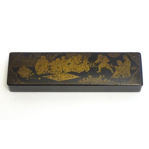 1164 - An early 20thC lacquered papier mache pen box decorated with a garden scene with Oriental figures pl... 