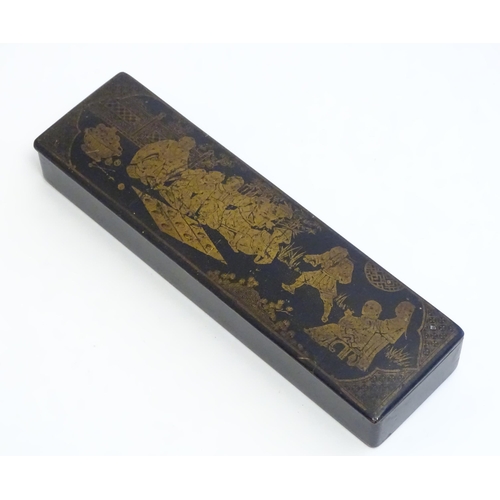 1164 - An early 20thC lacquered papier mache pen box decorated with a garden scene with Oriental figures pl... 