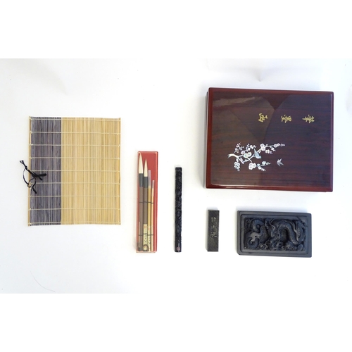 1165 - A late 20thC boxed Japanese calligraphy set, to include ink stone, brushes, brush rest etc. Box appr... 