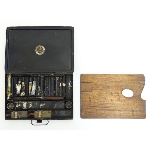 1175 - An early 20thC Reeves & Sons Ltd. artist's travelling tin / paint box with fitted interior palette, ... 