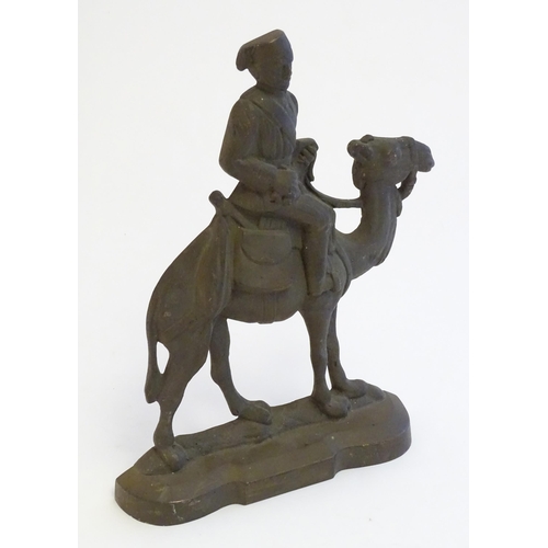 1261 - A 20thC cast door stop / door porter modelled as a man riding a camel. Approx. 11 1/4