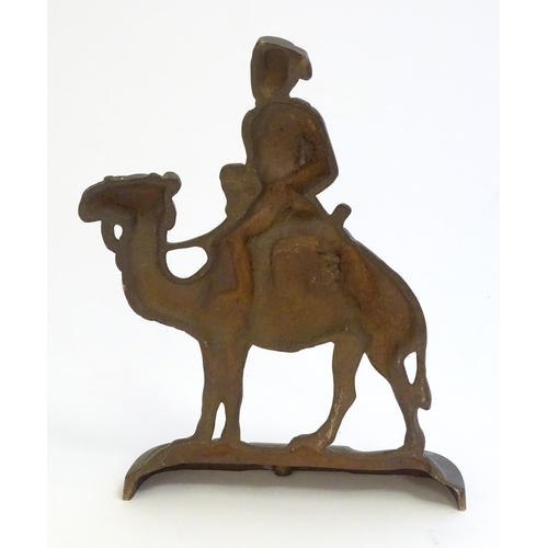 1261 - A 20thC cast door stop / door porter modelled as a man riding a camel. Approx. 11 1/4