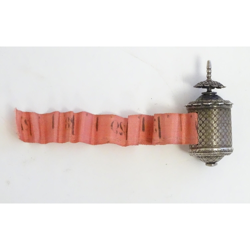 1279 - A Victorian white metal sewing tape measure. Approx. 1 1/2