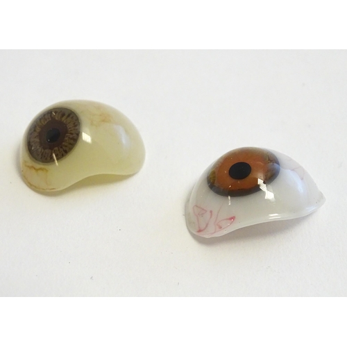 1295 - Two 19thC prosthetic glass human eyes with brown irises. Largest approx. 1