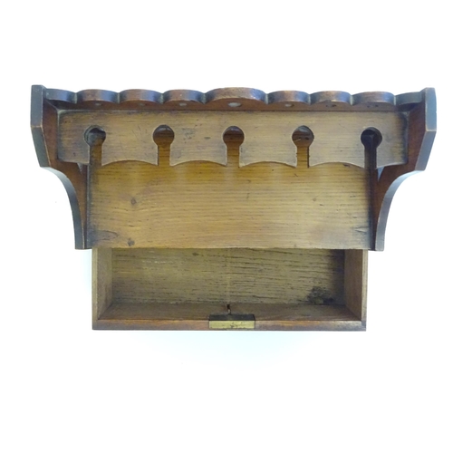 1332 - A late 19th / early 20thC oak pipe rack with the provision for 5 pipes, with a pierced back and draw... 