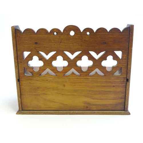 1332 - A late 19th / early 20thC oak pipe rack with the provision for 5 pipes, with a pierced back and draw... 