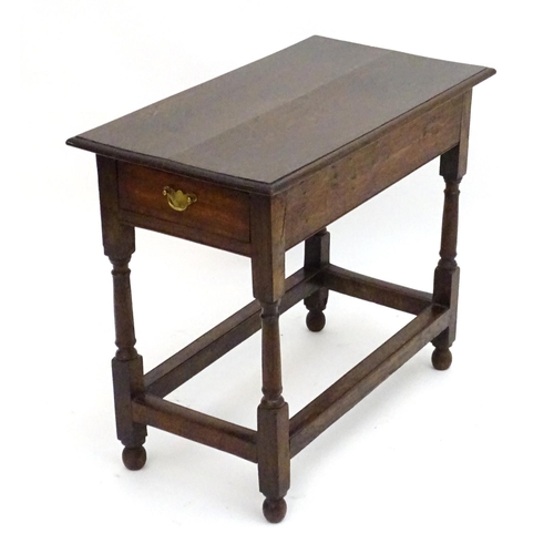 2080 - An early 20thC oak side table with a rectangular moulded top above a single long drawer and four tur... 