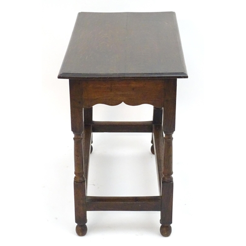 2080 - An early 20thC oak side table with a rectangular moulded top above a single long drawer and four tur... 