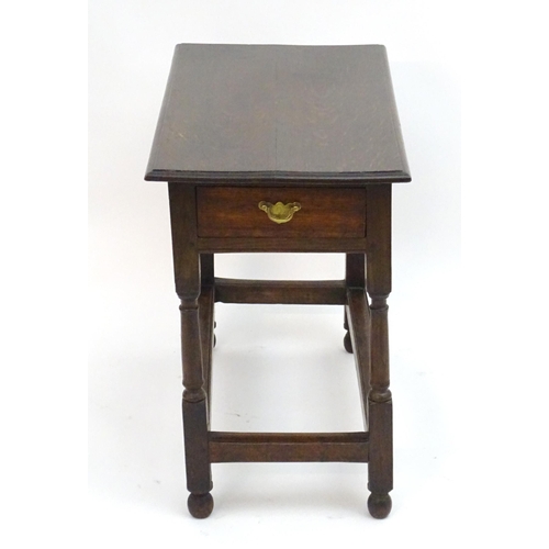 2080 - An early 20thC oak side table with a rectangular moulded top above a single long drawer and four tur... 