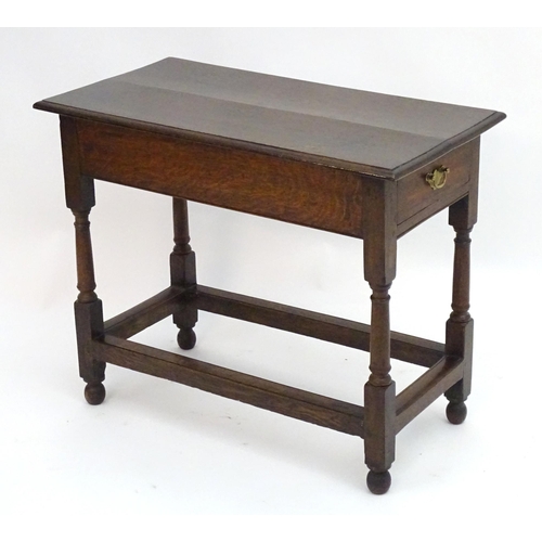 2080 - An early 20thC oak side table with a rectangular moulded top above a single long drawer and four tur... 