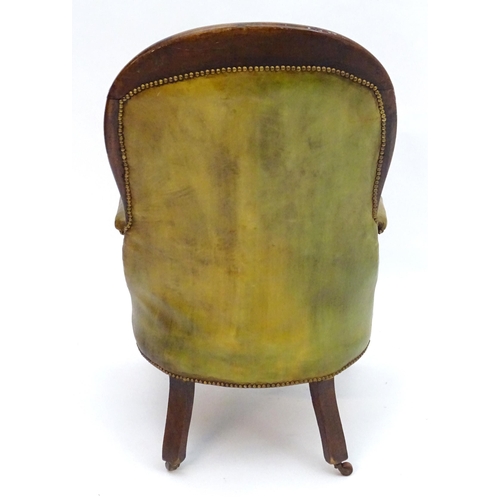 2084 - A Victorian mahogany armchair with a moulded frame and deep buttoned leather upholstery with brass s... 