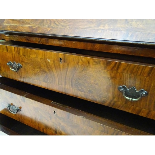 2088 - A late 19thC / early 20thC walnut bureau with a fall front above three long drawers having brass han... 