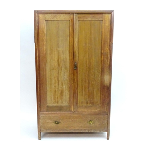 2089 - An early 20thC walnut 'Maple & Co' wardrobe with two doors opening to show hooks and a hanging rail,... 