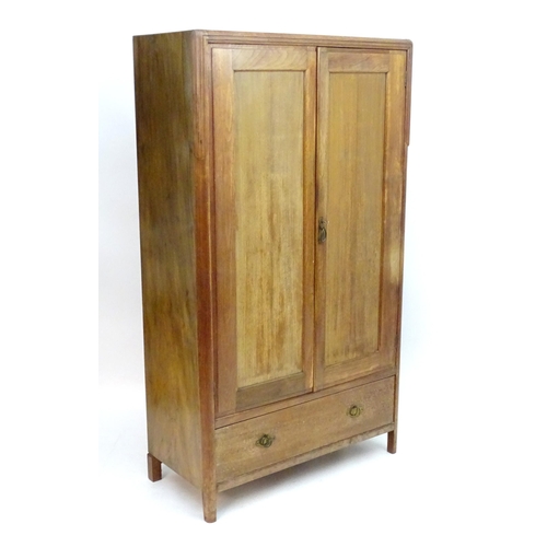 2089 - An early 20thC walnut 'Maple & Co' wardrobe with two doors opening to show hooks and a hanging rail,... 