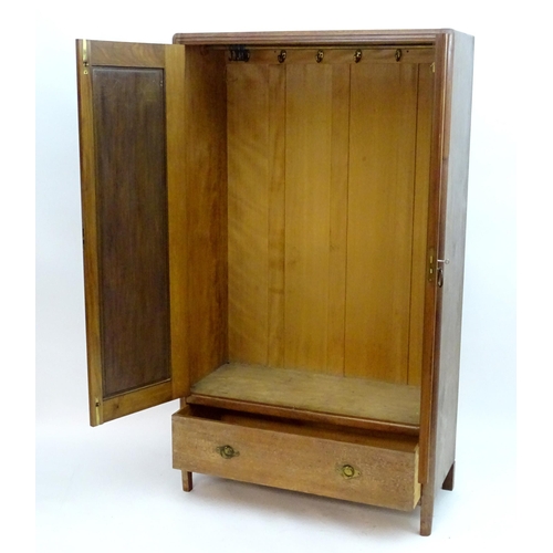 2089 - An early 20thC walnut 'Maple & Co' wardrobe with two doors opening to show hooks and a hanging rail,... 