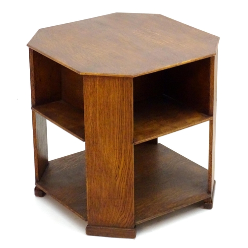 2103 - An Art Deco oak octagonal three tier table. 22 1/2