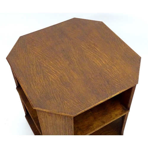 2103 - An Art Deco oak octagonal three tier table. 22 1/2