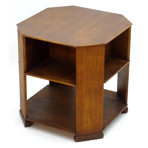 2103 - An Art Deco oak octagonal three tier table. 22 1/2