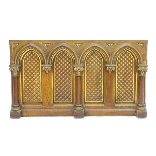 2105 - An ecclesiastical Gothic panel with columns, moulded arches, gilt painted decoration and floral moti... 