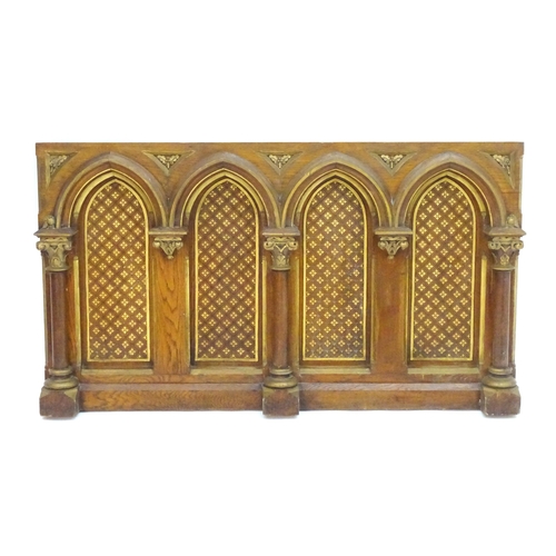 2105 - An ecclesiastical Gothic panel with columns, moulded arches, gilt painted decoration and floral moti... 