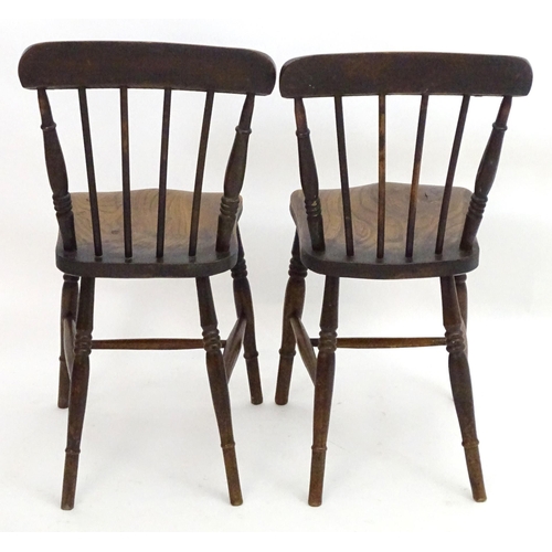 2106 - A pair of late 19thC Windsor chairs with shaped top rails and spindle backs above elm seats and turn... 