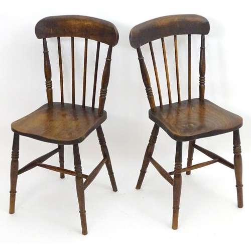 2106 - A pair of late 19thC Windsor chairs with shaped top rails and spindle backs above elm seats and turn... 