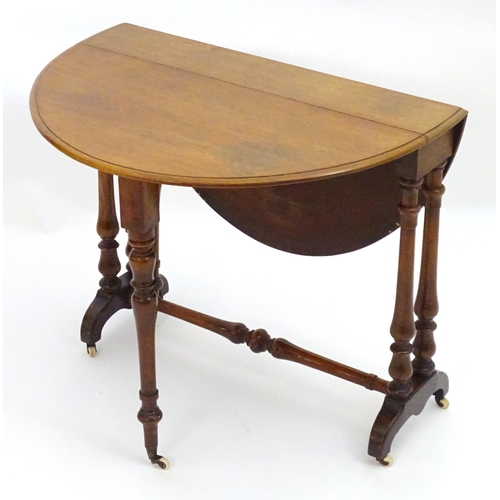 2114 - A mid / late 19thC walnut Sutherland table with drop flaps, turned legs and a tapering turned stretc... 