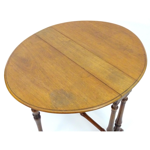 2114 - A mid / late 19thC walnut Sutherland table with drop flaps, turned legs and a tapering turned stretc... 