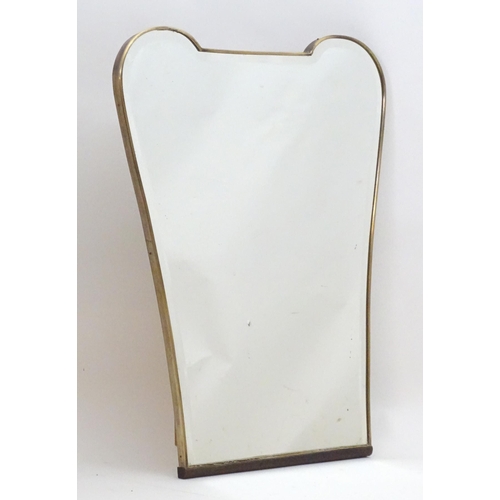 2222A - Vintage Retro, Mid-century: a 1950s bevelled mirror of tapering form, with brass frame, 24 1/2