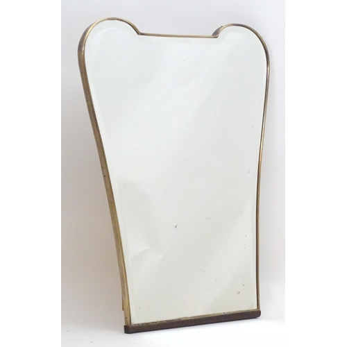 2222A - Vintage Retro, Mid-century: a 1950s bevelled mirror of tapering form, with brass frame, 24 1/2