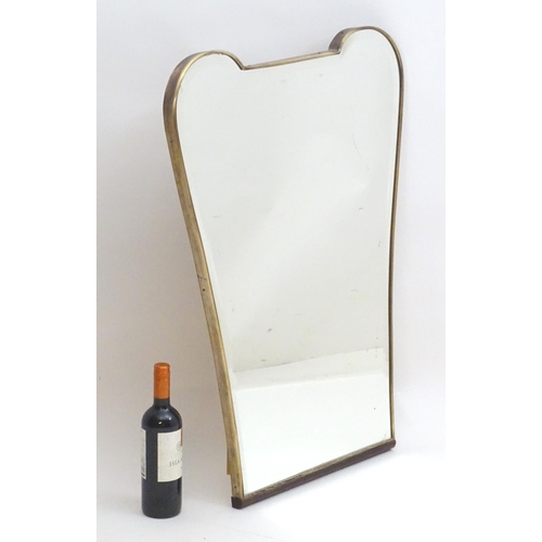 2222A - Vintage Retro, Mid-century: a 1950s bevelled mirror of tapering form, with brass frame, 24 1/2