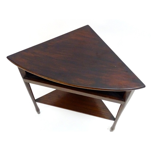 2227 - Vintage Retro, Mid-century: a mahogany low corner table, the tripod base with pocket and shelf under... 