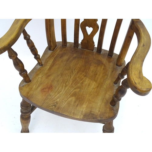 2100A - An early 20thC beech lathe back open armchair with a top rail and pierced central splat above a shap... 