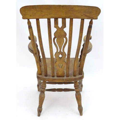 2100A - An early 20thC beech lathe back open armchair with a top rail and pierced central splat above a shap... 