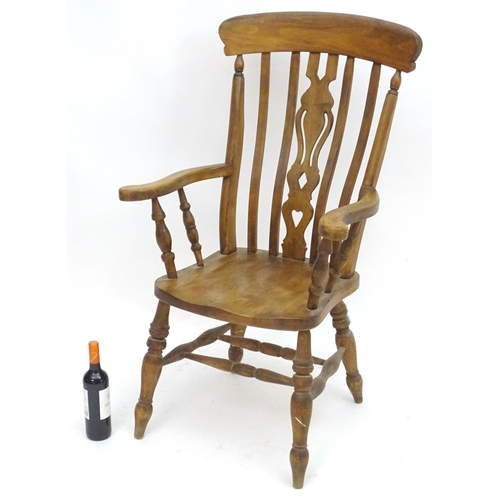 2100A - An early 20thC beech lathe back open armchair with a top rail and pierced central splat above a shap... 