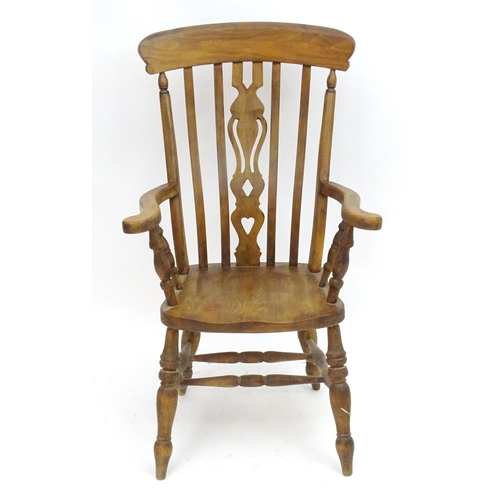 2100A - An early 20thC beech lathe back open armchair with a top rail and pierced central splat above a shap... 