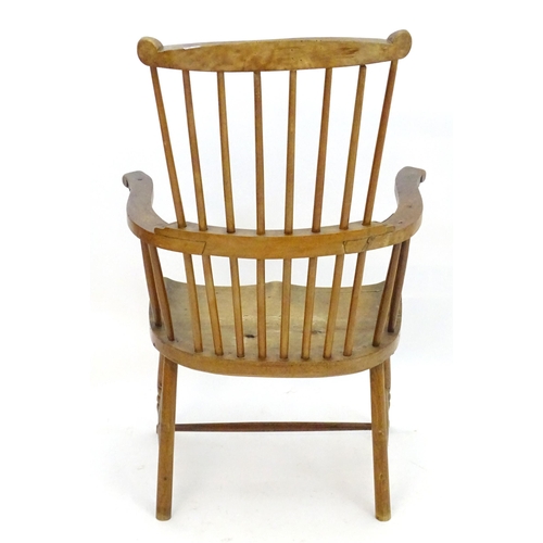 2118 - An early / mid 19thC comb back Windsor chair with a double bow back and saddle seat above turned tap... 