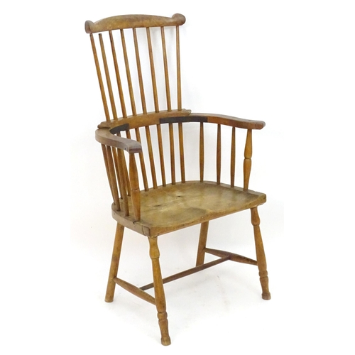 2118 - An early / mid 19thC comb back Windsor chair with a double bow back and saddle seat above turned tap... 