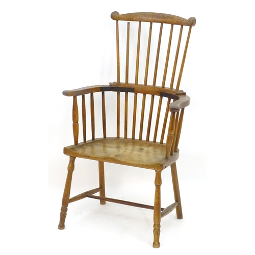 2118 - An early / mid 19thC comb back Windsor chair with a double bow back and saddle seat above turned tap... 