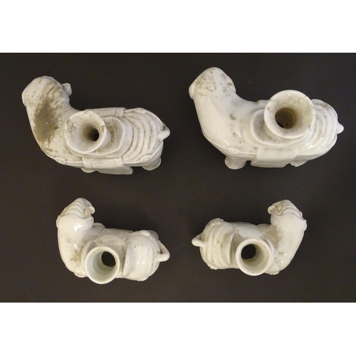 42 - Four Chinese blanc de chine bud vases modelled as elephants. Largest 6 1/2